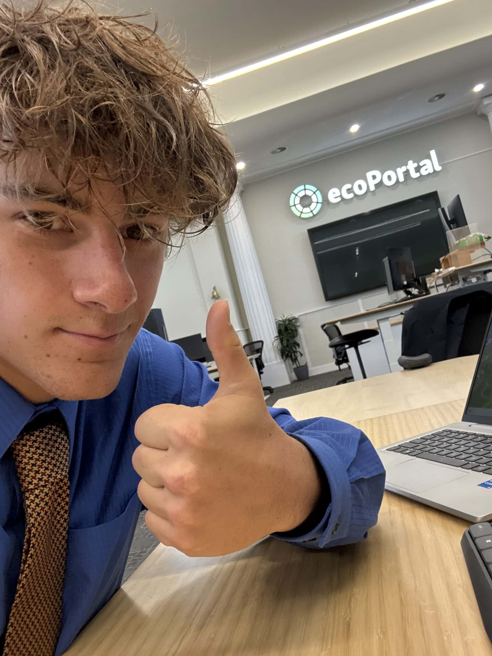 Andrew Bachrodt giving a thumbs up in the ecoPortal office.