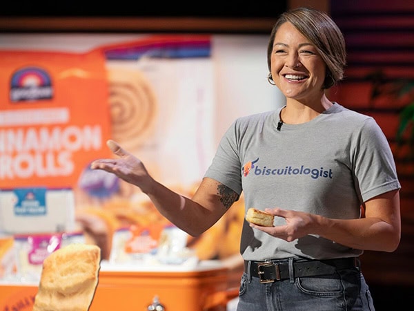 Chennelle Diong holding a biscuit on the set of Shark Tank