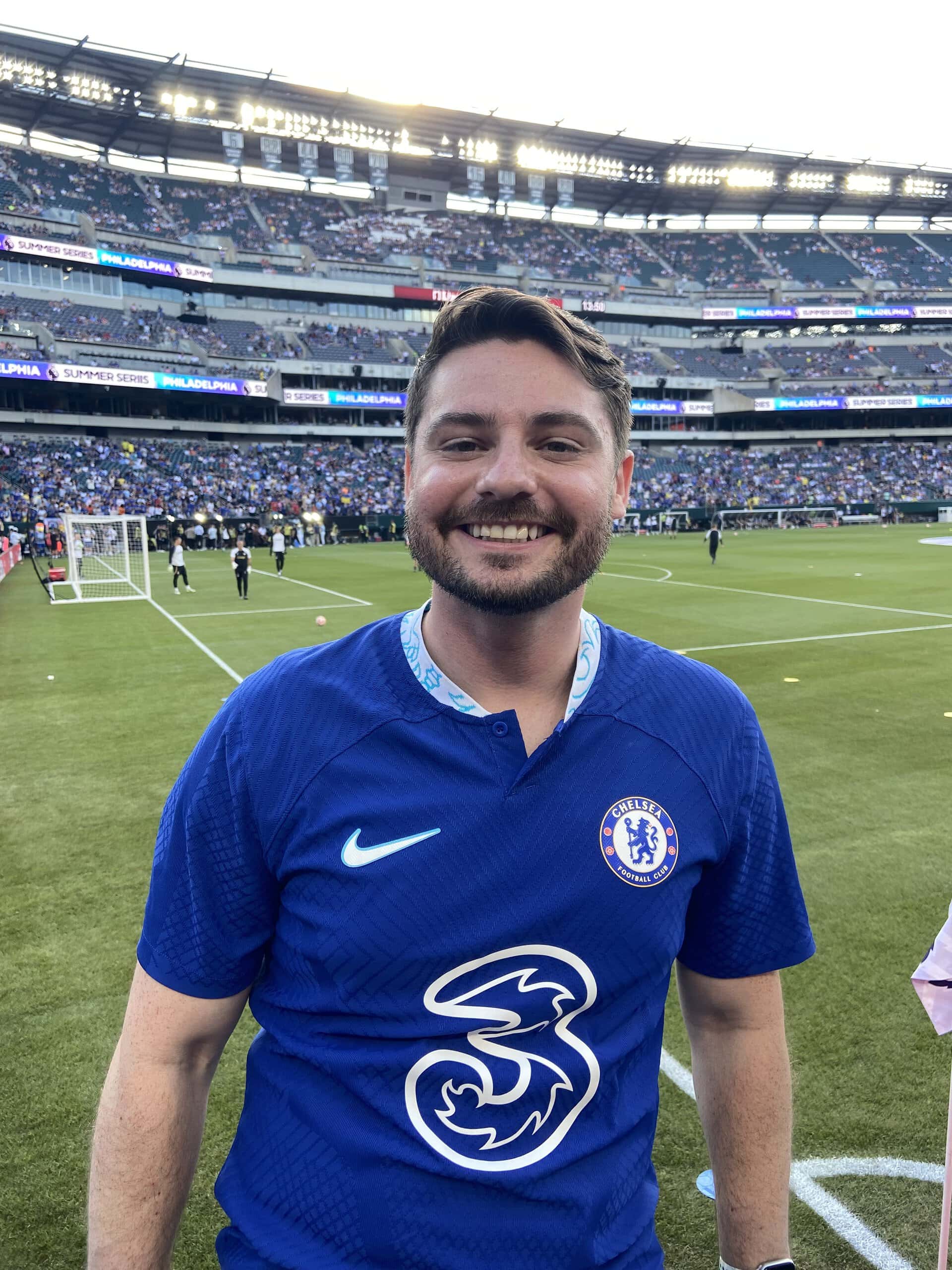 Chris Lee in a soccer jersey standing on a field