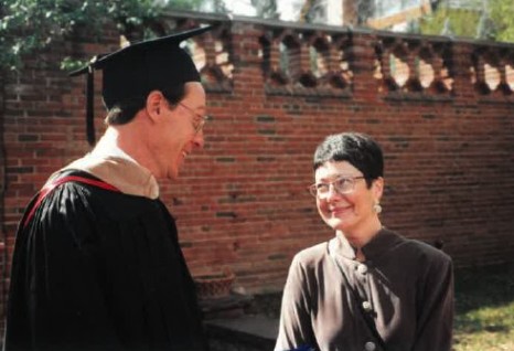 Cindi Fukami smiling at someone wearing a cap and gown