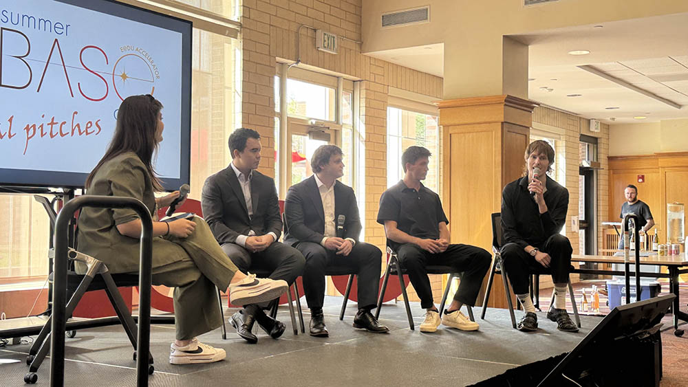 Students presenting a final business pitch to judges and classmates during a Daniels College classroom competition.