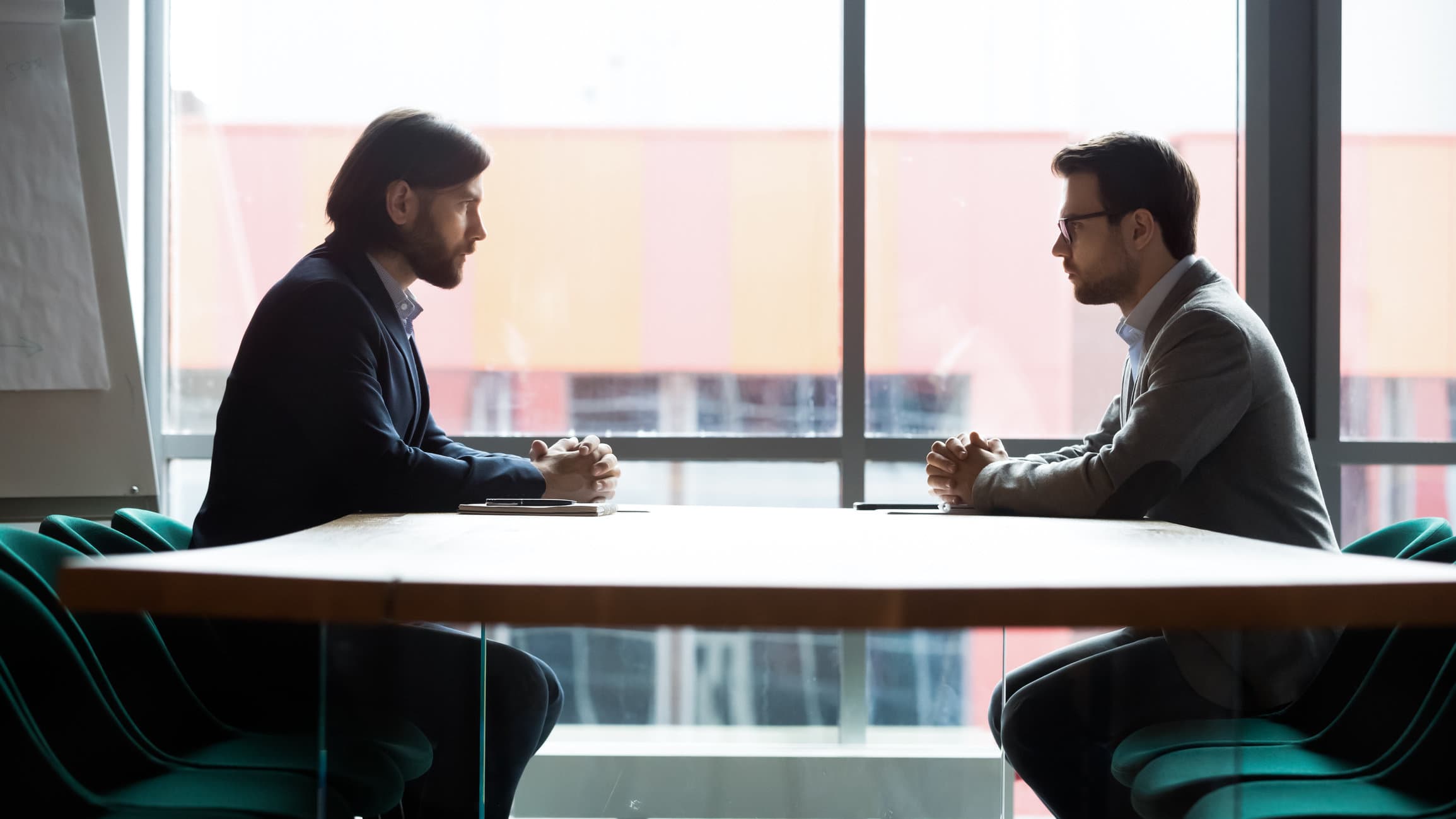 Two men sitting across from each other at a table