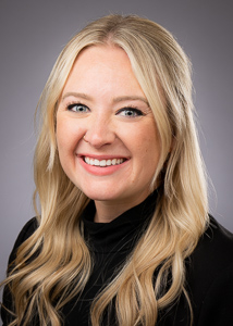 Hannah Hansard, Assistant Director of Graduate Admissions at the Daniels College of Business, University of Denver, smiling in a professional portrait.