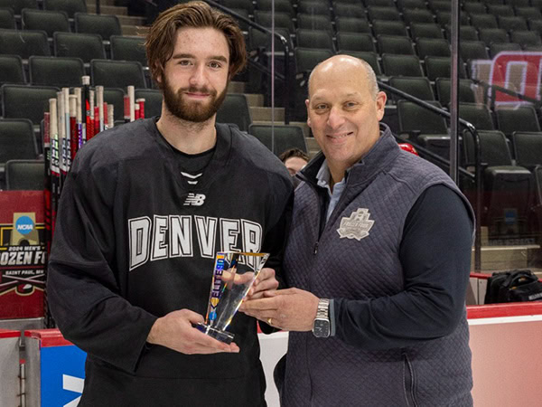 Kent Anderson receiving a trophy for academic excellence