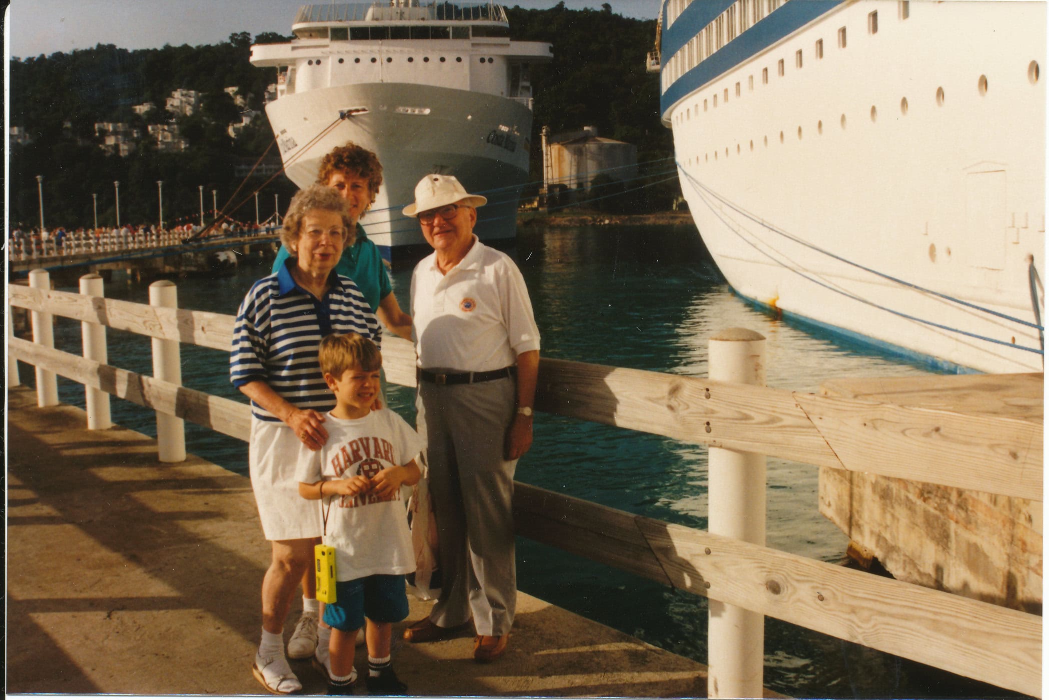 The Kesselmans standing on a dock in front of boats