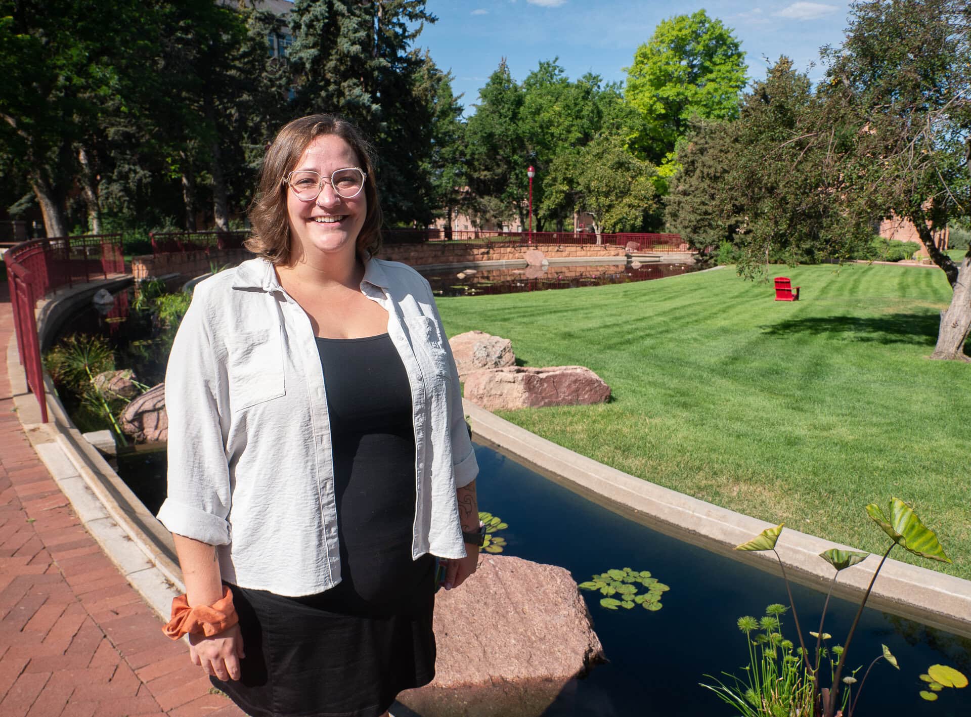Lexi Warden standing near water in a garden on campus