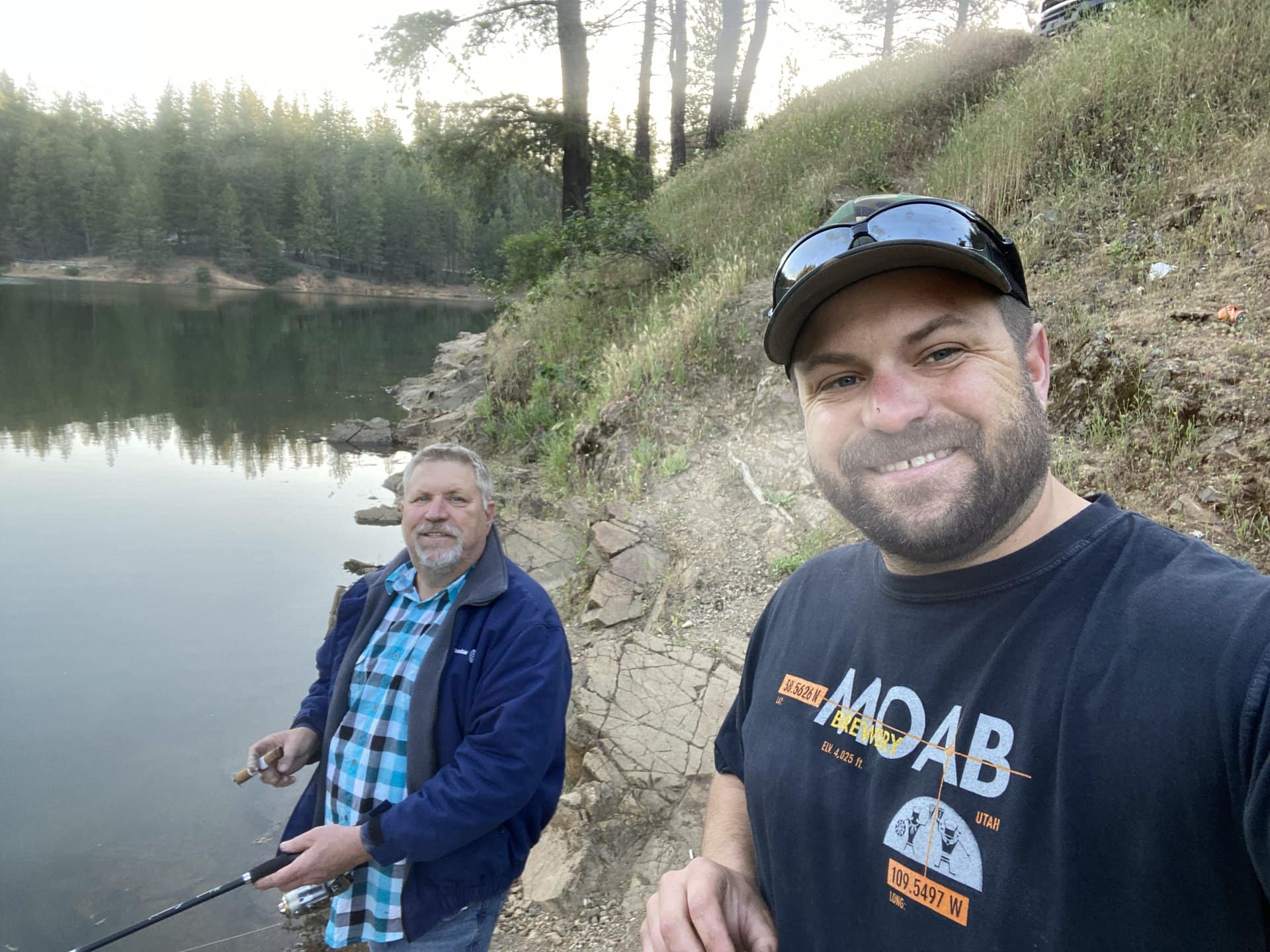 Marc Bastnagel standing with his dad with a fishing rod