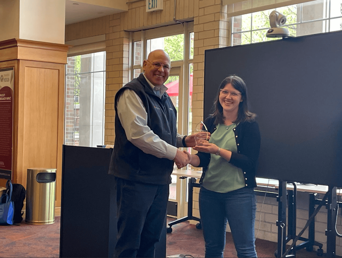 Lowell Valencia-Miller presenting Mary-Margaret Koch with a plaque