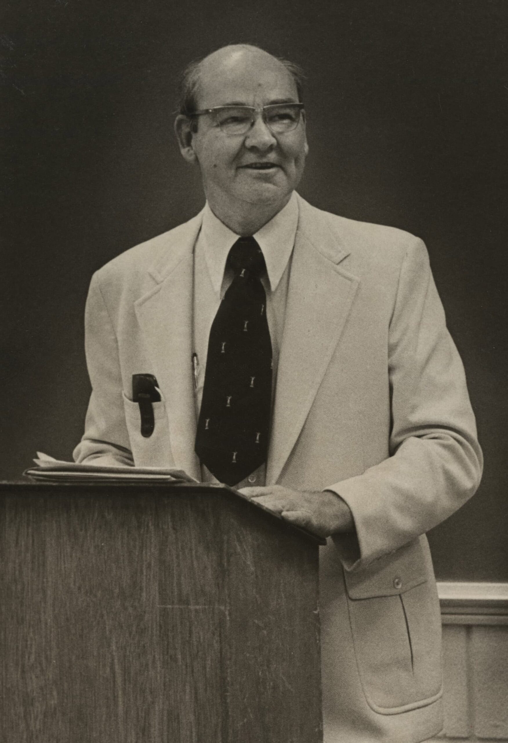 Peter Firmin in a suit at a lectern