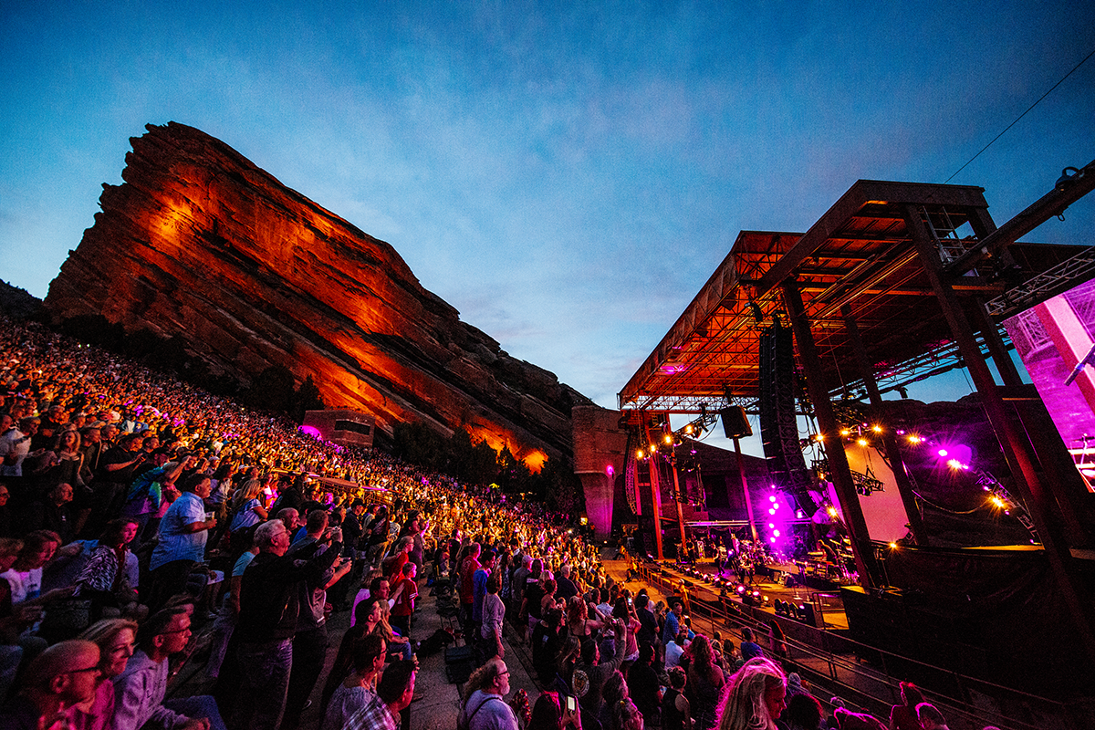 Red rocks at night with an audience watching the act on stage