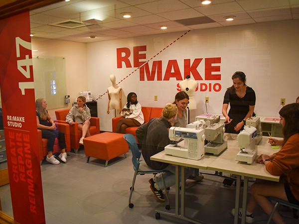 Students working in a studio on sewing machines