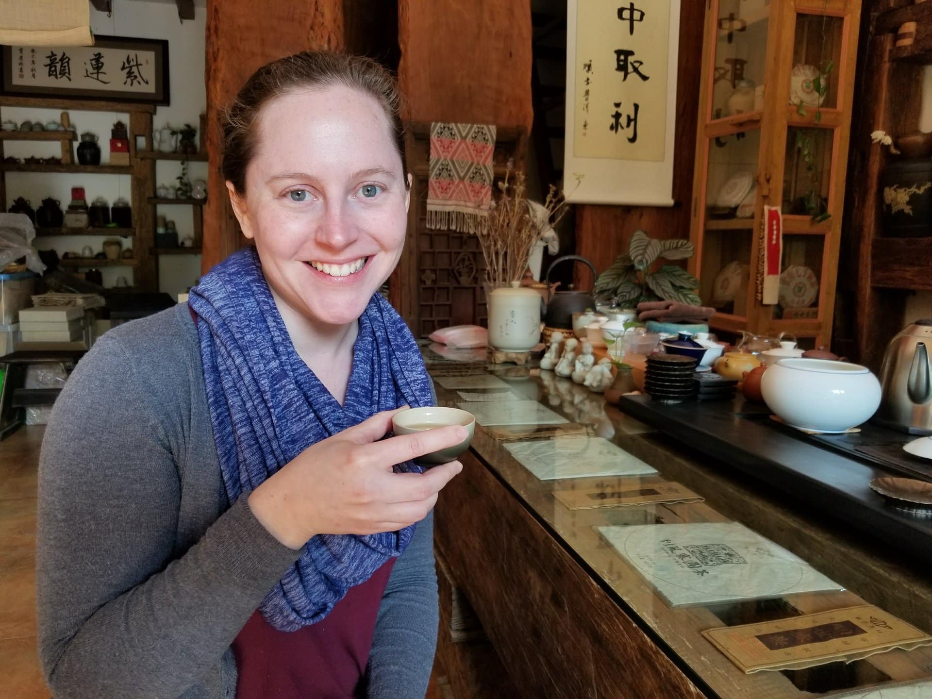 Sara Bularzik holds up a cup of tea at a Chinese tea house