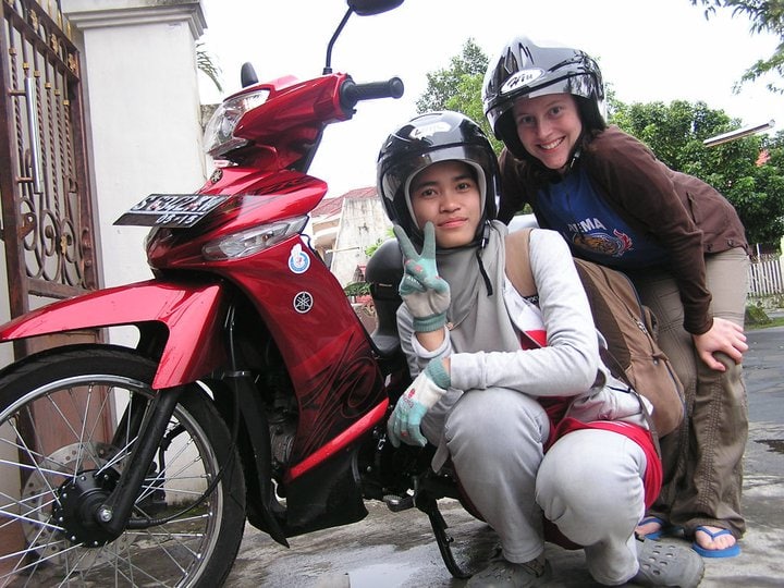 Sara Bularzik poses with someone next to a motorbike in Indonesia