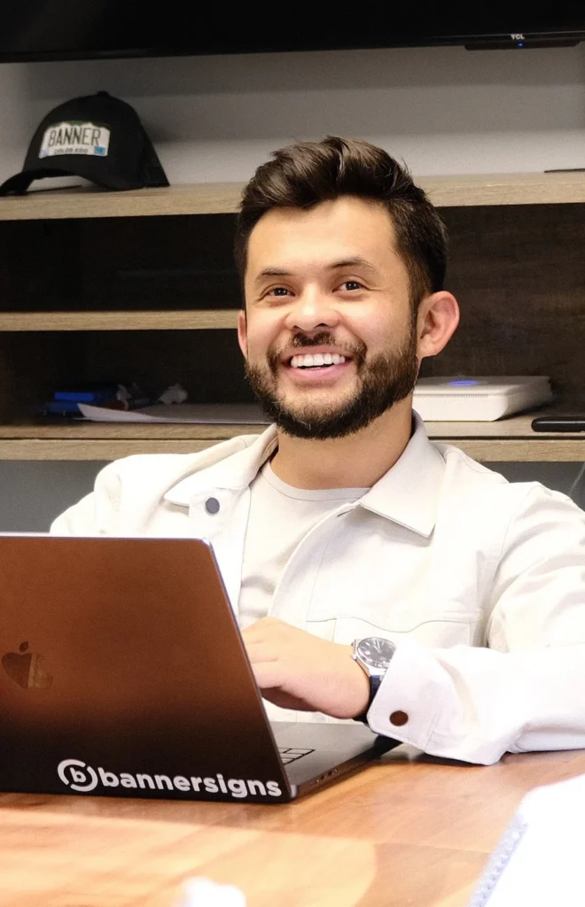 Ivan Hernandez sitting with a laptop