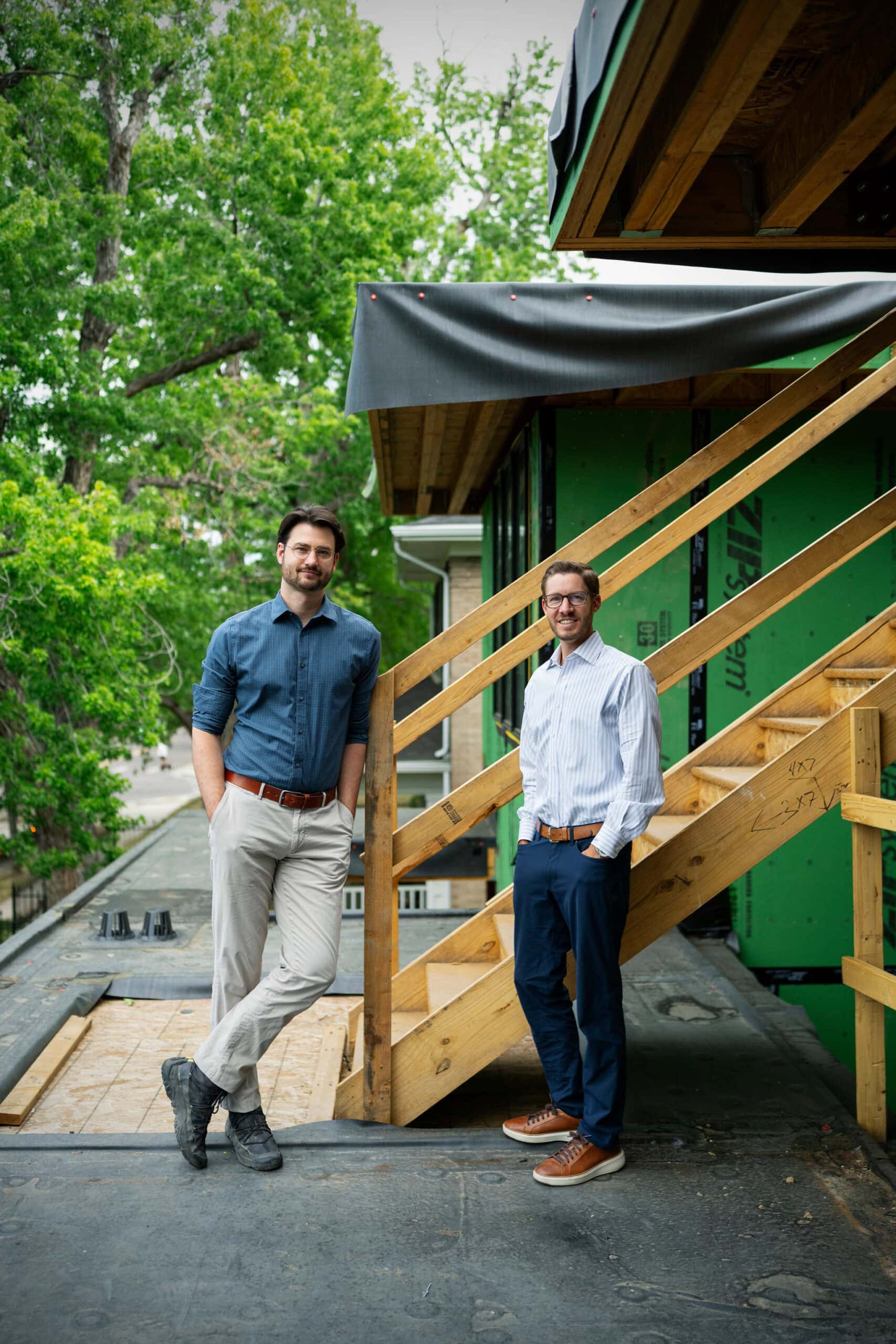 Jeff Nickless and John Schrader standing beside a staircase