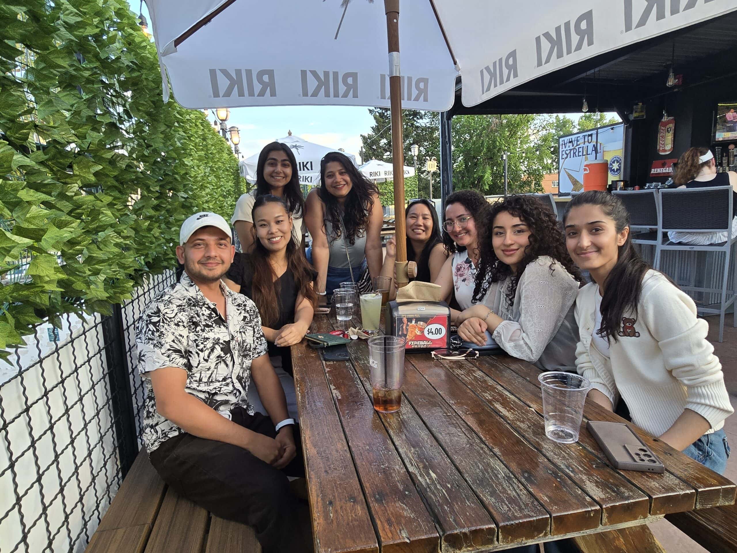 A group of Nepalese students at a restaurant table