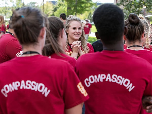 Students wearing shirts that say "compassion" on the back