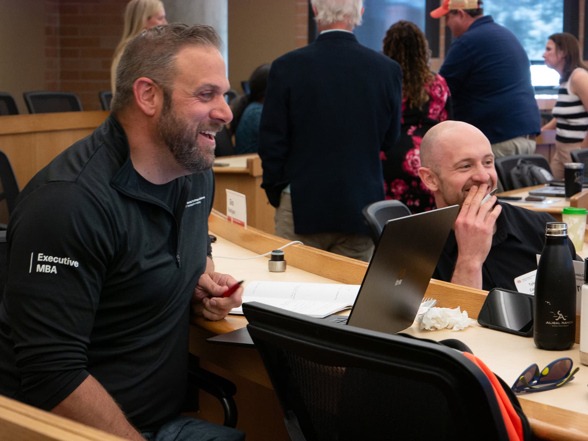 EMBA students smiling in class